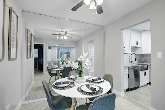 dining area featuring sink, ceiling fan, and light hardwood / wood-style floors