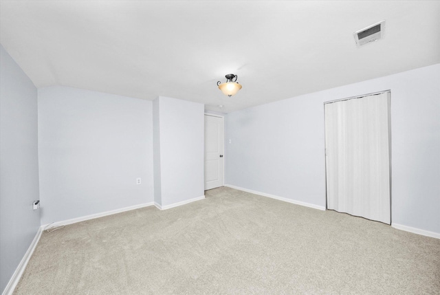 empty room featuring light colored carpet