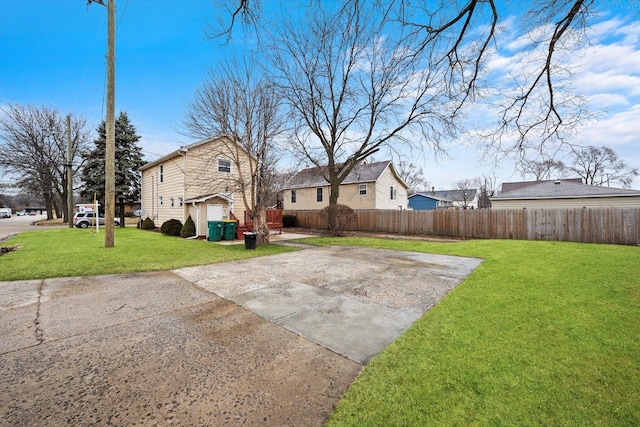 back of house with a yard and a patio