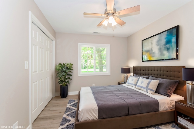 bedroom featuring ceiling fan, a closet, and light hardwood / wood-style flooring