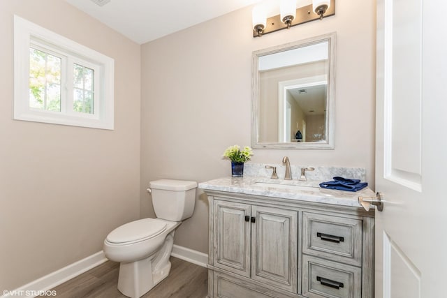 bathroom featuring hardwood / wood-style flooring, vanity, and toilet