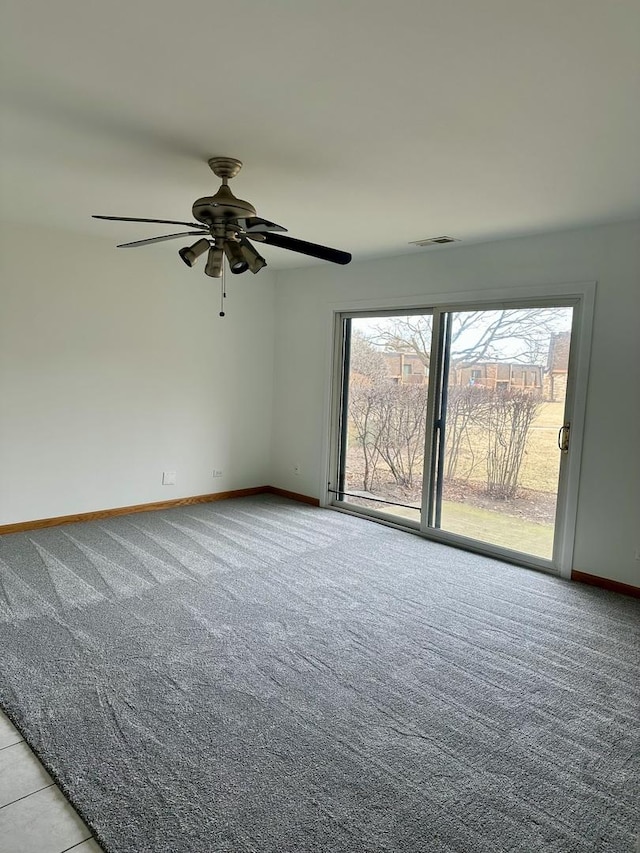 spare room featuring ceiling fan and light carpet