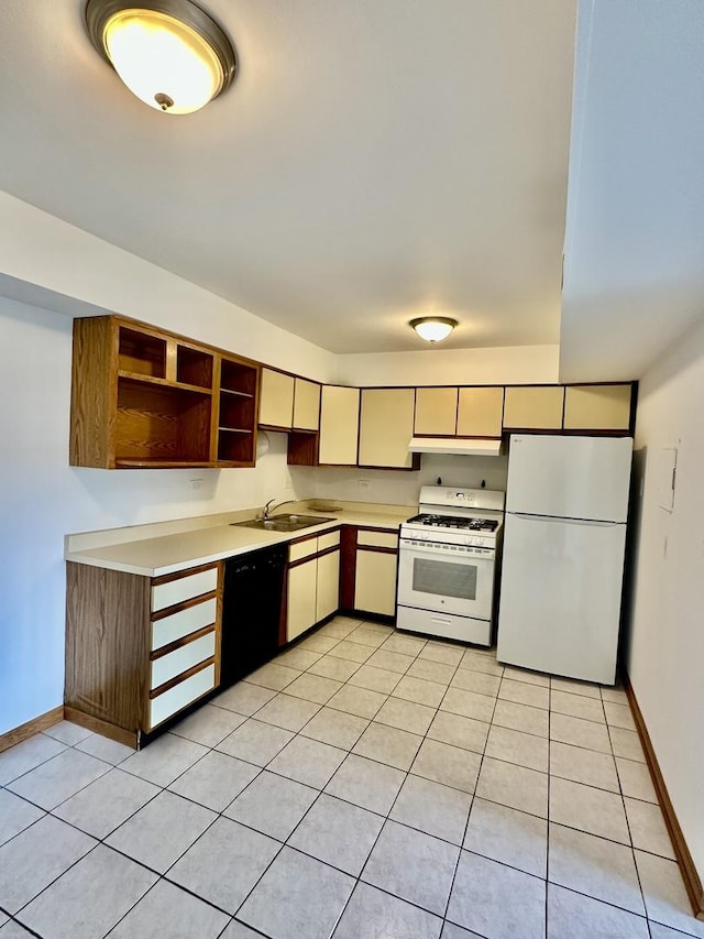 kitchen featuring sink, white appliances, and light tile patterned flooring