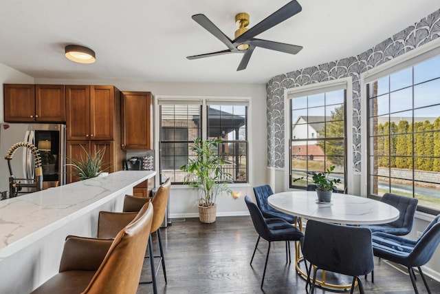 dining space featuring dark wood-type flooring and ceiling fan