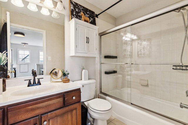 full bathroom with vanity, tile patterned floors, shower / bath combination with glass door, and toilet