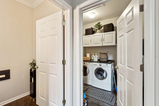 laundry room with cabinets, dark tile patterned floors, and washer and clothes dryer