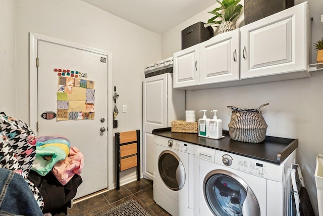 washroom featuring cabinets, independent washer and dryer, and dark tile patterned flooring