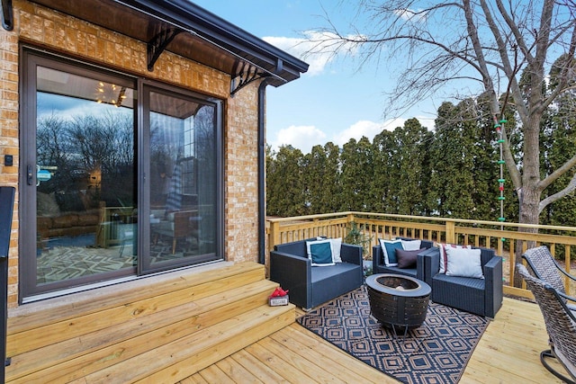 wooden deck with an outdoor living space with a fire pit