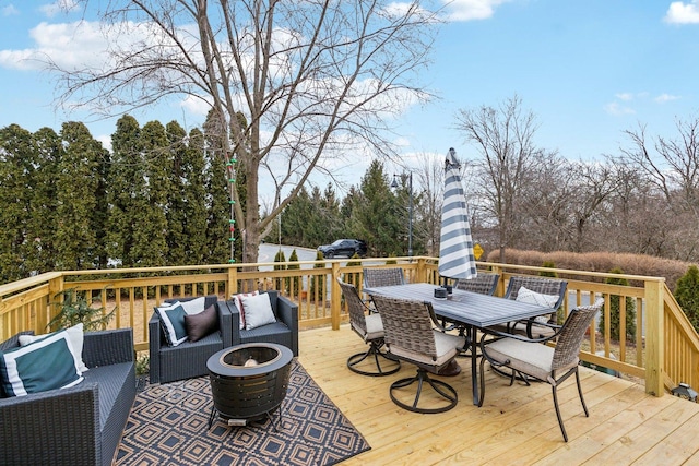 deck featuring an outdoor living space with a fire pit