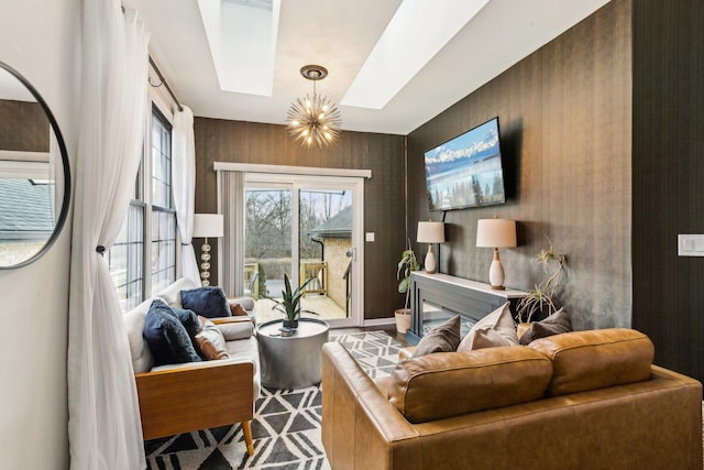 living room with a skylight and a notable chandelier