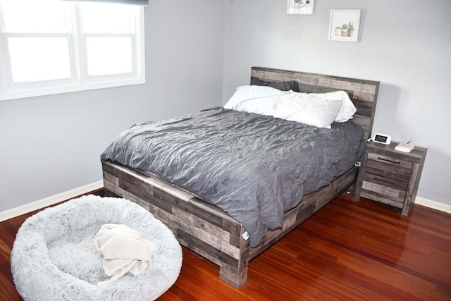 bedroom with dark wood-type flooring