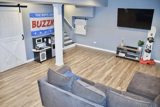 living room with hardwood / wood-style flooring and a barn door