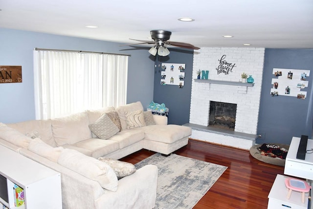 living room with ceiling fan, dark hardwood / wood-style floors, and a fireplace