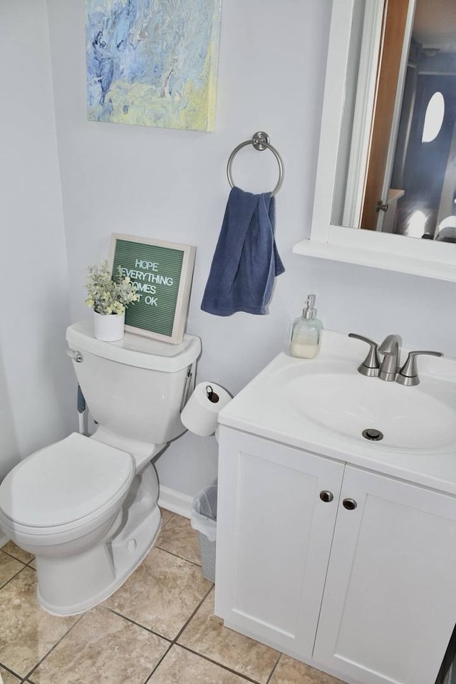 bathroom featuring vanity, tile patterned floors, and toilet