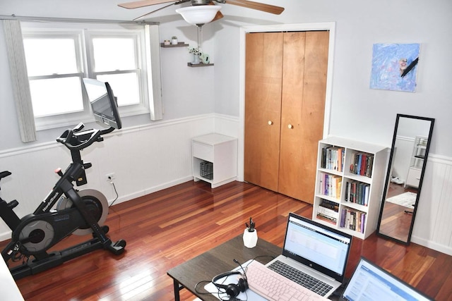 exercise room with dark wood-type flooring and ceiling fan