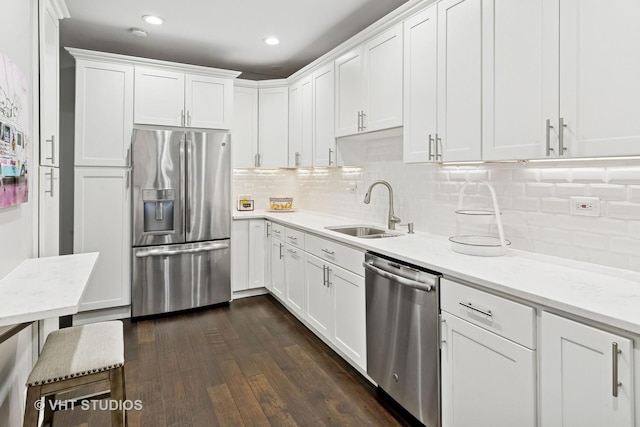 kitchen featuring white cabinetry, stainless steel appliances, and a sink