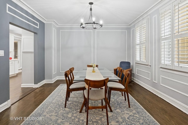 dining room featuring ornamental molding and a decorative wall