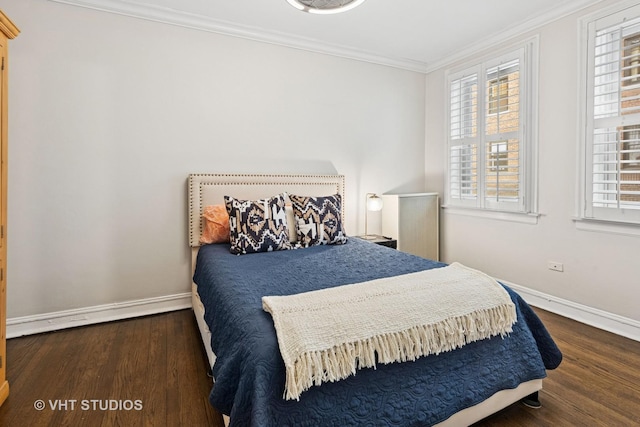 bedroom featuring baseboards, ornamental molding, and wood finished floors