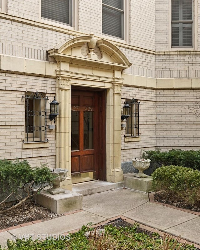 entrance to property with brick siding