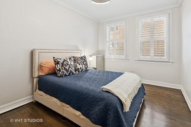 bedroom featuring crown molding, baseboards, and wood finished floors