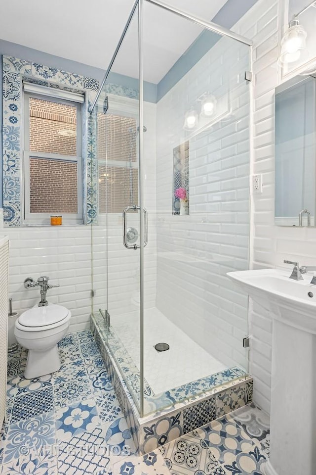 full bathroom featuring toilet, a stall shower, tile walls, and tile patterned floors