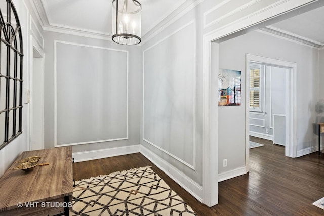 interior space featuring crown molding, visible vents, wood finished floors, a chandelier, and baseboards