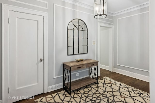 interior space featuring baseboards, crown molding, and wood finished floors