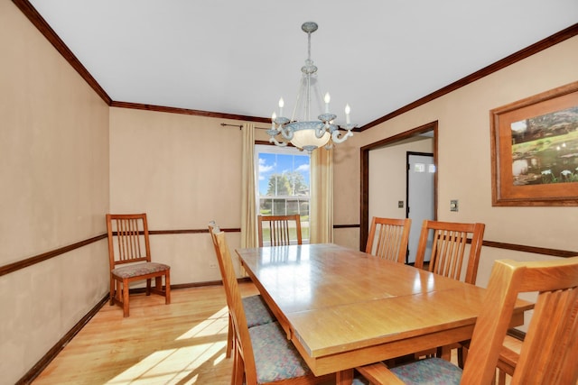 dining area with crown molding, a chandelier, and light wood-type flooring