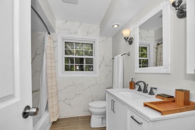 full bathroom with vanity, plenty of natural light, toilet, and shower / bathtub combination with curtain