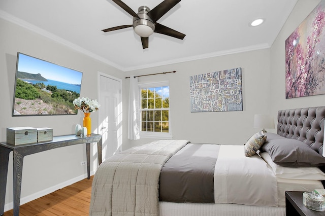 bedroom with crown molding, wood-type flooring, and ceiling fan