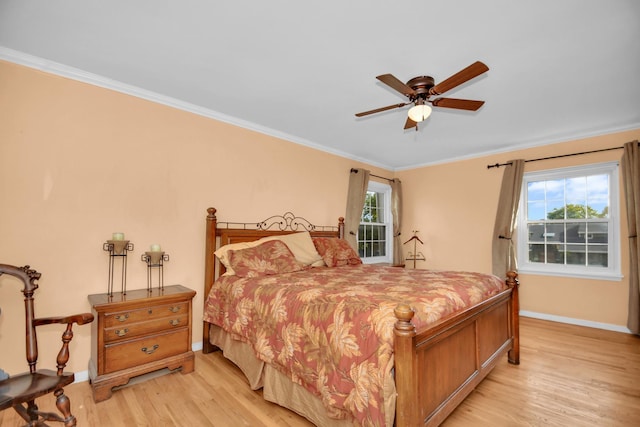 bedroom featuring ceiling fan, ornamental molding, and light hardwood / wood-style flooring