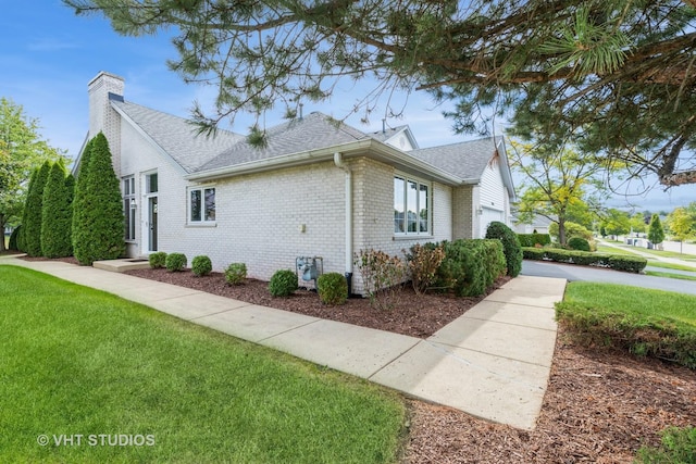 view of side of home with a lawn