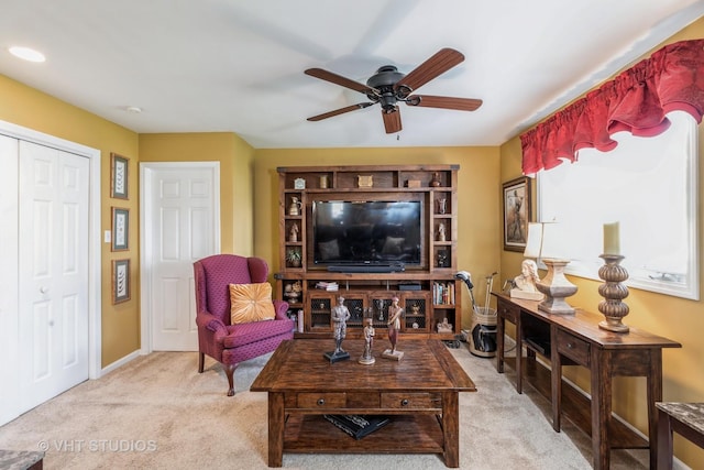 carpeted living room with ceiling fan