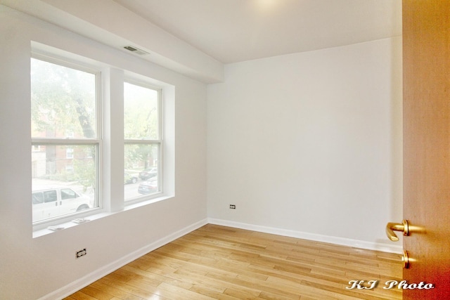 spare room with light hardwood / wood-style flooring