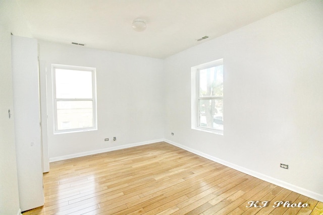 spare room with light hardwood / wood-style flooring