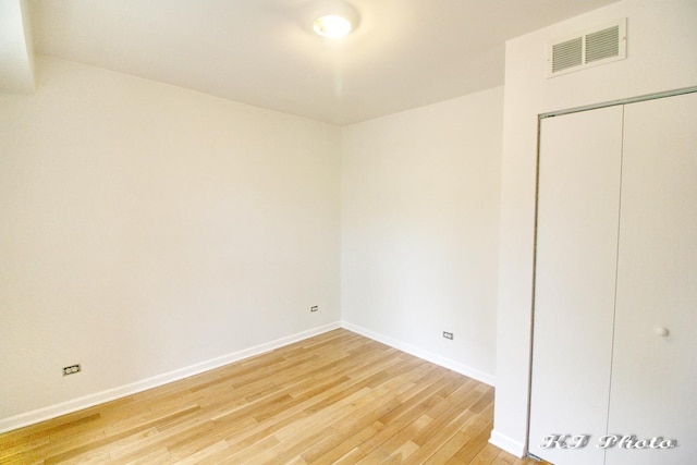 unfurnished bedroom featuring hardwood / wood-style floors and a closet