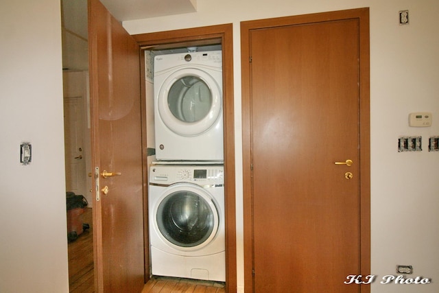 clothes washing area featuring stacked washer / dryer