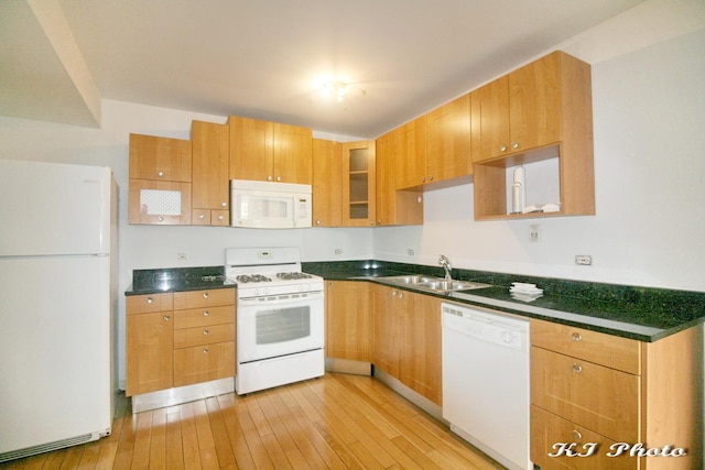 kitchen with white appliances, sink, and light wood-type flooring