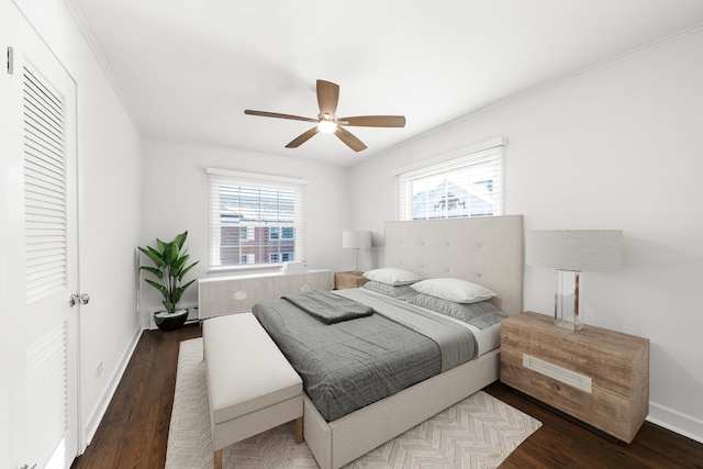 bedroom featuring ceiling fan, ornamental molding, and dark hardwood / wood-style floors