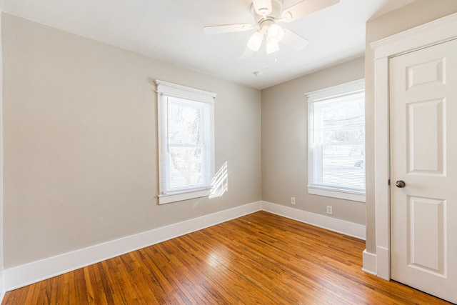 spare room featuring ceiling fan and hardwood / wood-style floors