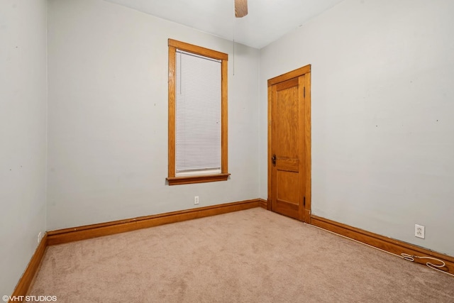 spare room with light carpet and ceiling fan