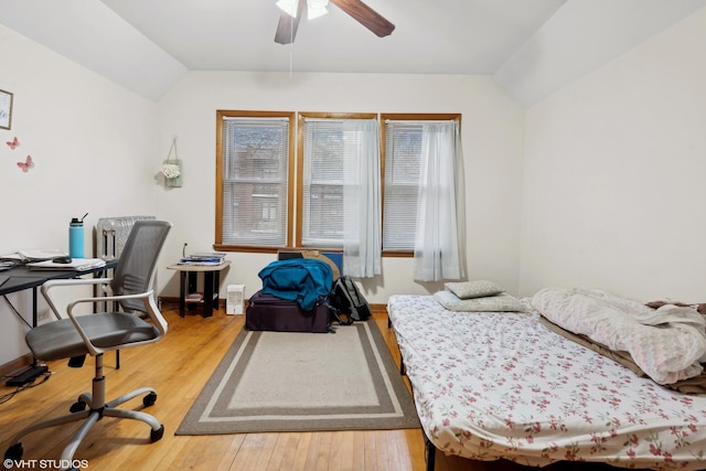 bedroom with lofted ceiling, hardwood / wood-style floors, and ceiling fan