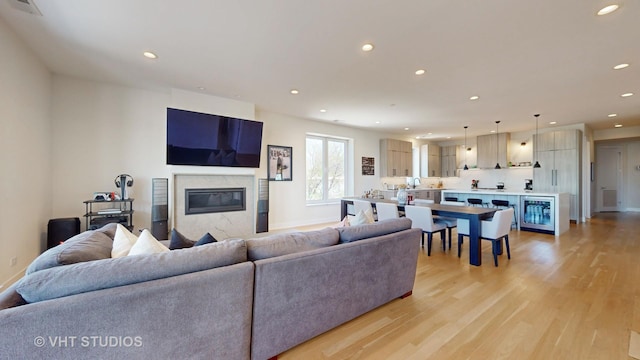 living room featuring light hardwood / wood-style floors and a premium fireplace