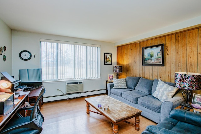 living room with wood walls, baseboard heating, and light wood-type flooring