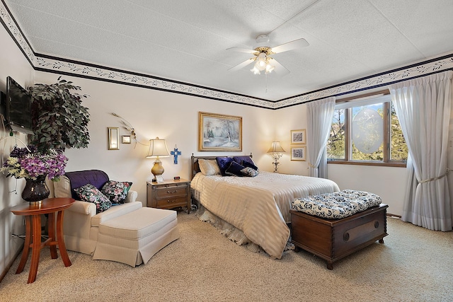 carpeted bedroom with a textured ceiling and ceiling fan