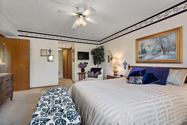 bedroom featuring light colored carpet, a textured ceiling, and ceiling fan