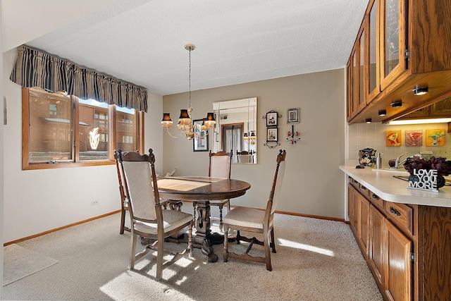 dining room with light carpet and an inviting chandelier
