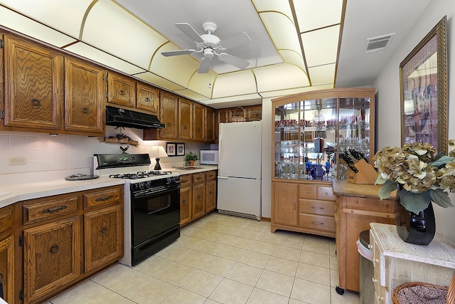 kitchen with light tile patterned floors, white appliances, decorative backsplash, and ceiling fan