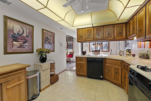 kitchen with black appliances, sink, light tile patterned floors, ceiling fan, and kitchen peninsula
