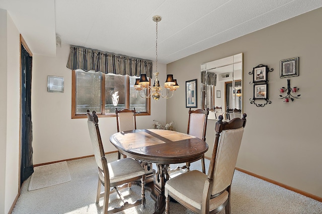 dining space with light colored carpet and a chandelier